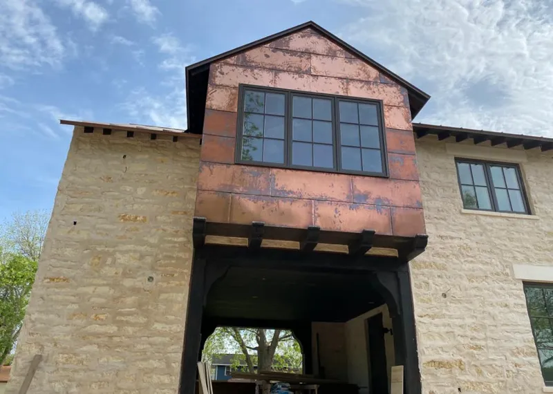 Copper metal panel facade on a stone building for Skylight Installation in Hopkinton